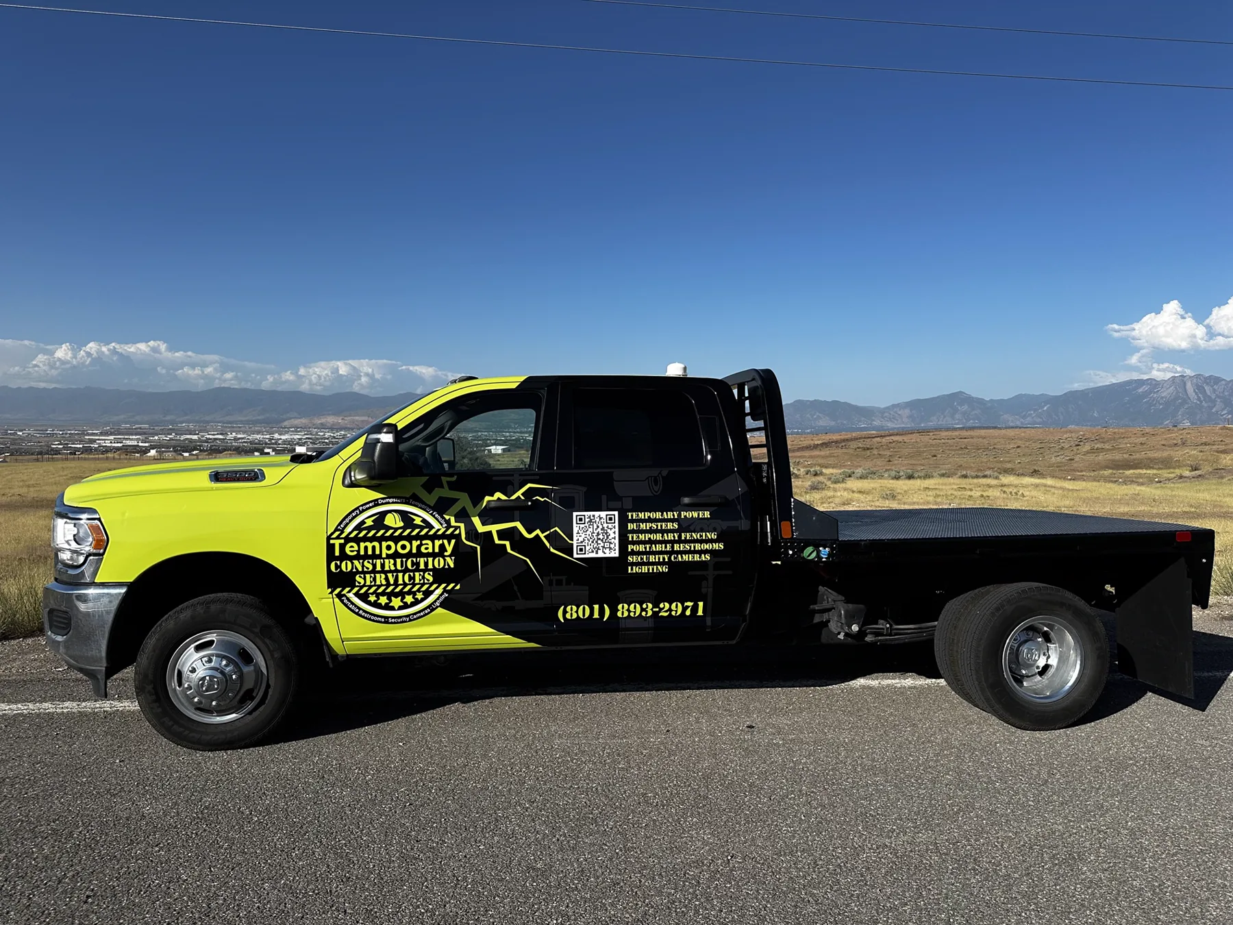 Official Temporary Construction Services utility truck on a Utah jobsite with mountains in the background